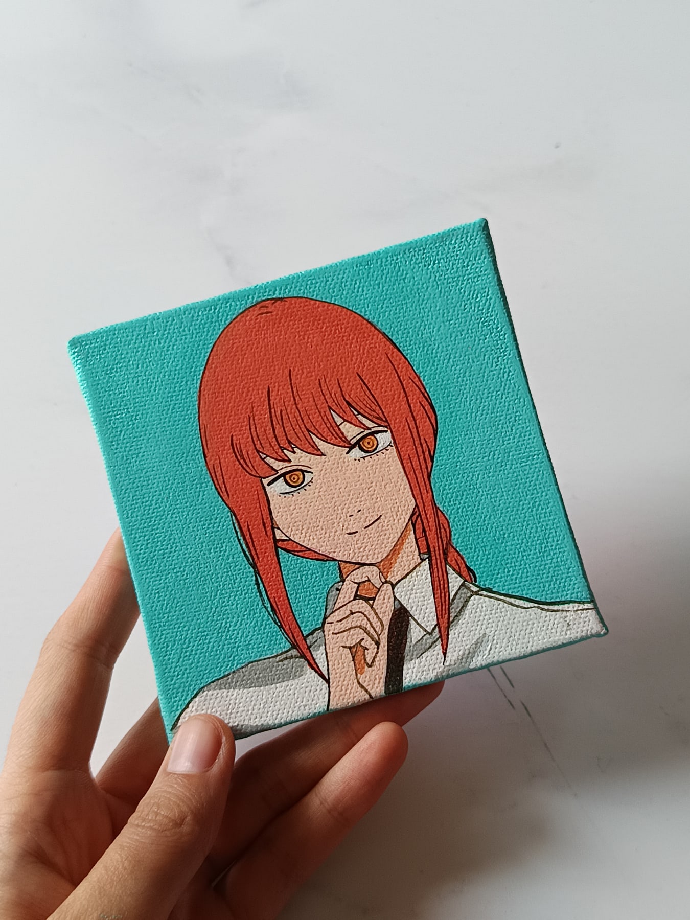 Side view of Makima hand-painted mini canvas fridge magnet by Tulika Viegas