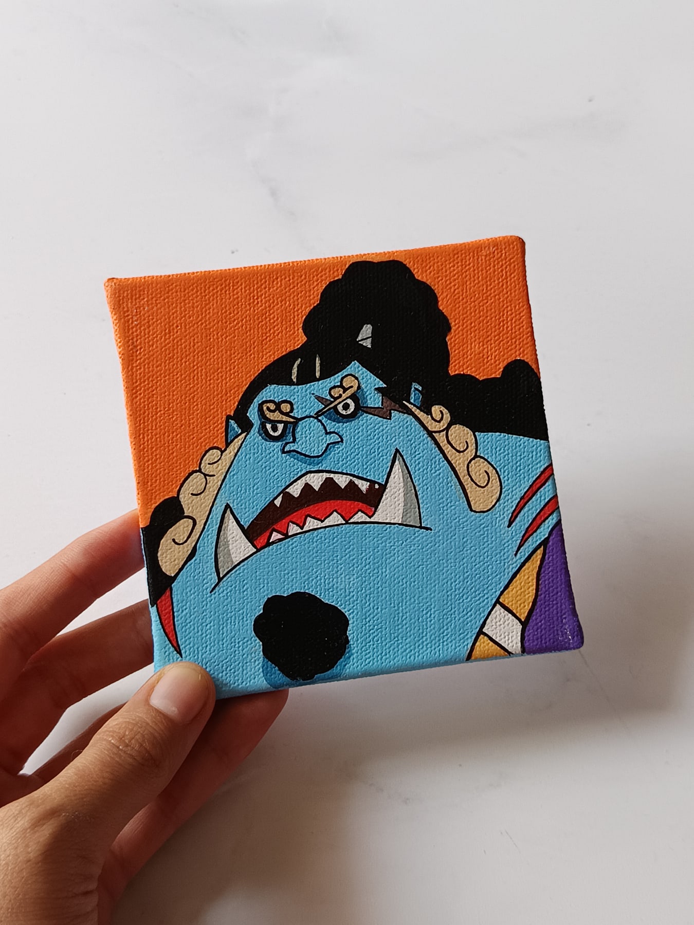 Side view of Jinbe hand-painted mini canvas fridge magnet by Tulika Viegas
