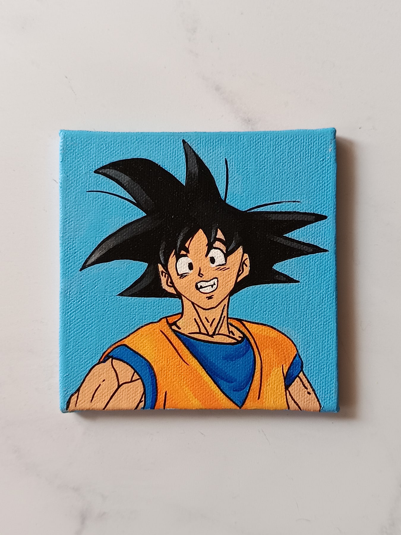 Side view of Son Goku hand-painted mini canvas fridge magnet by Tulika Viegas