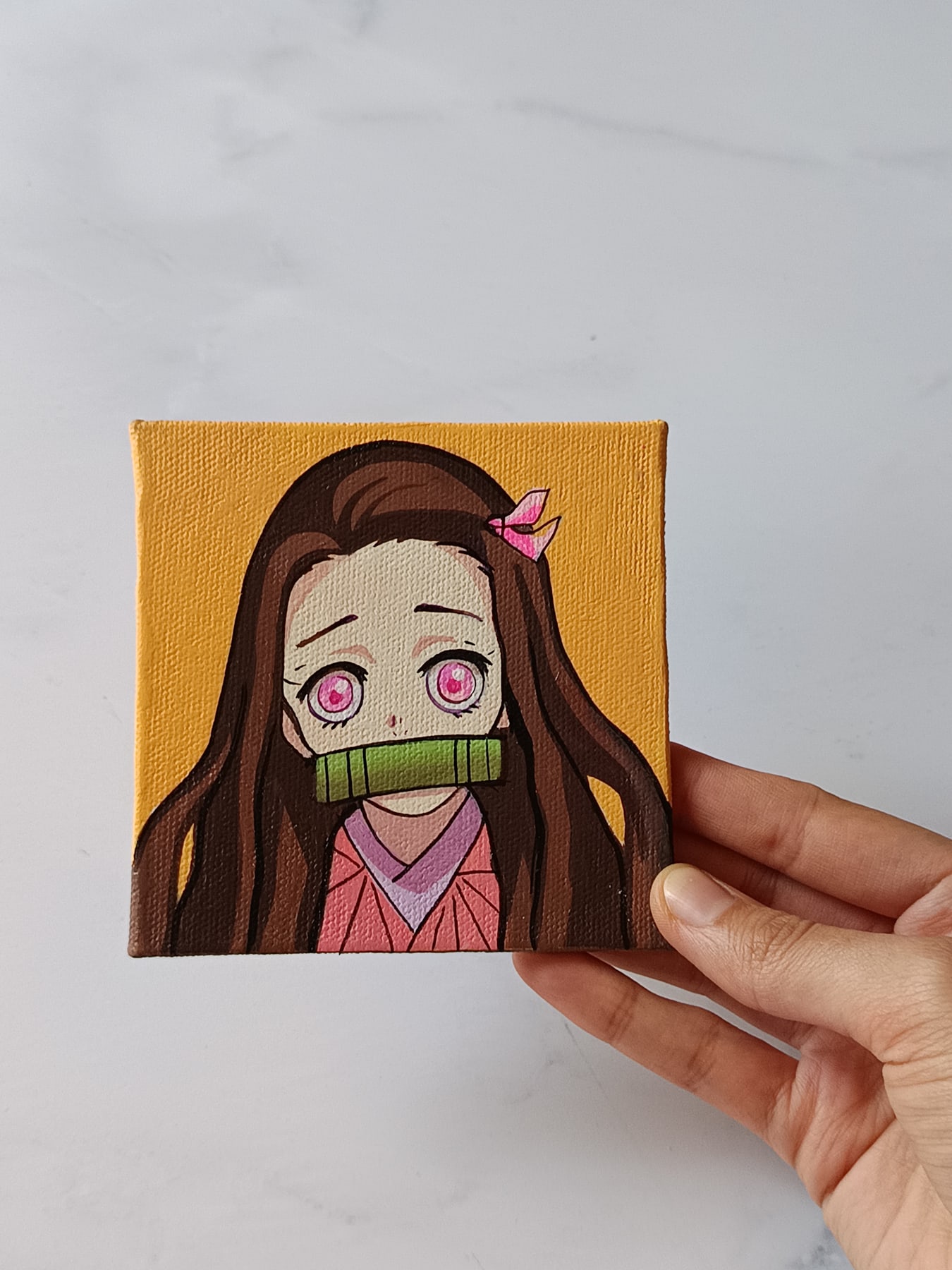 Side view of Nezuko Kamado hand-painted mini canvas fridge magnet by Tulika Viegas