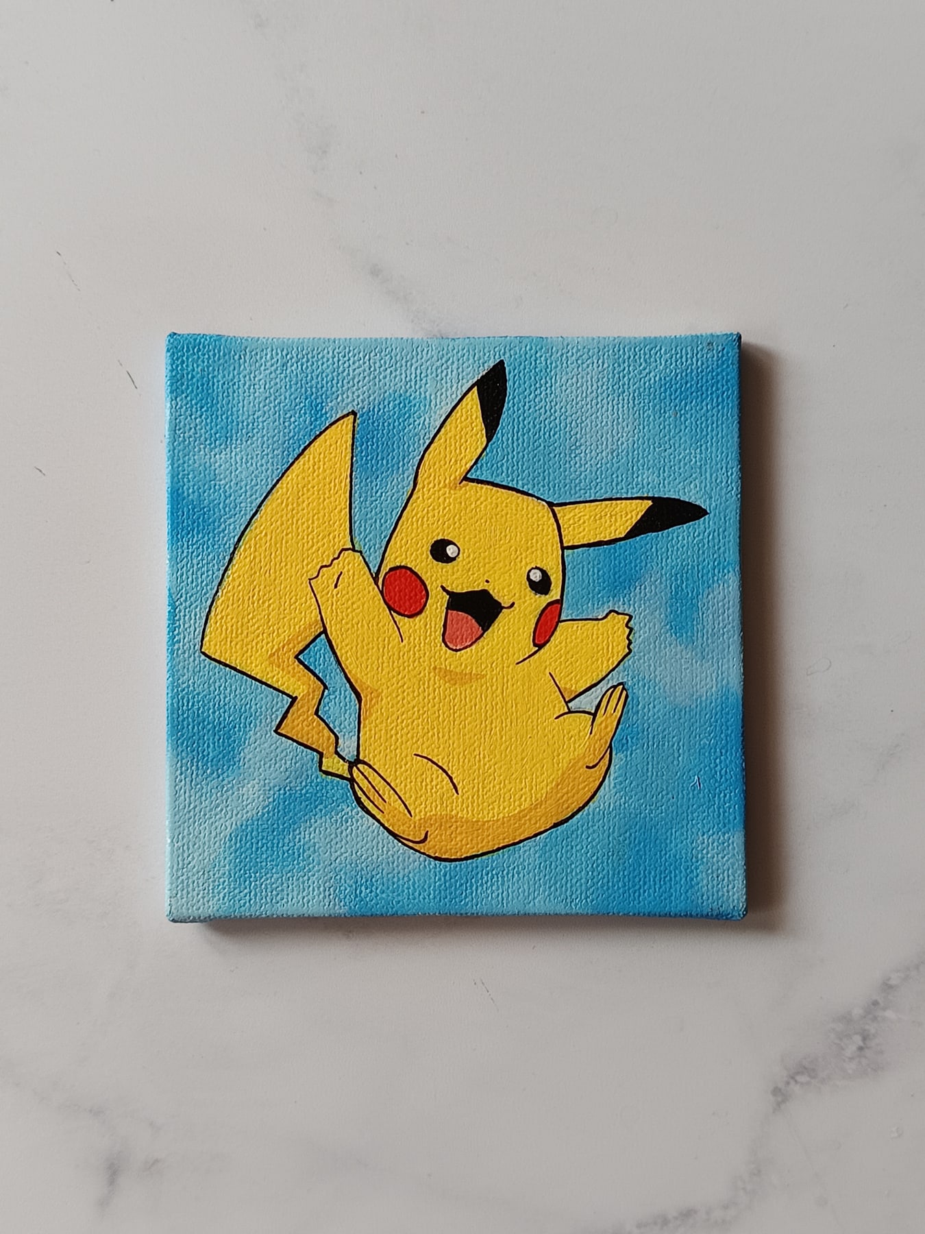 Side view of Jumping Pikachu hand-painted mini canvas fridge magnet by Tulika Viegas