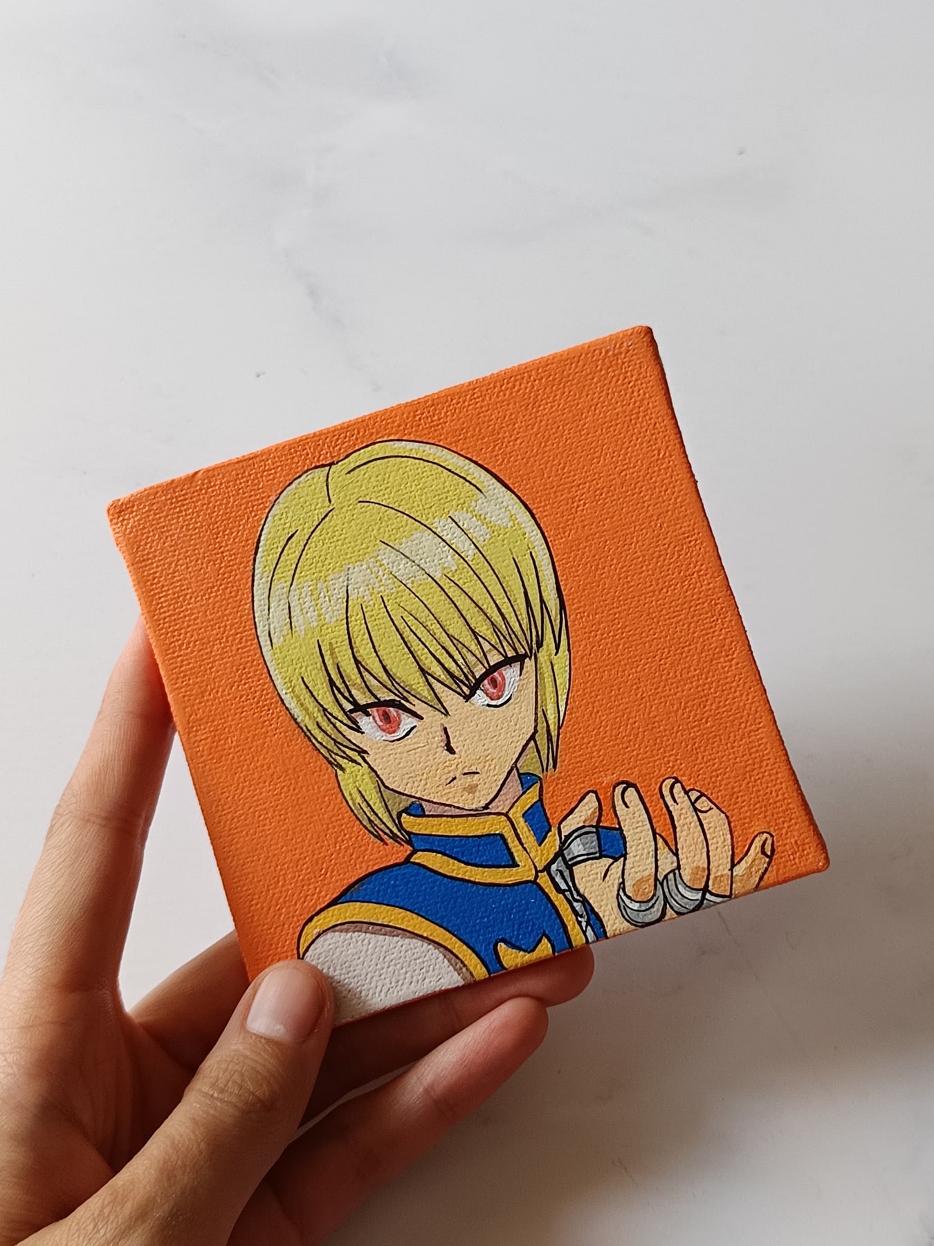 Side view of Kurapika hand-painted mini canvas fridge magnet by Tulika Viegas