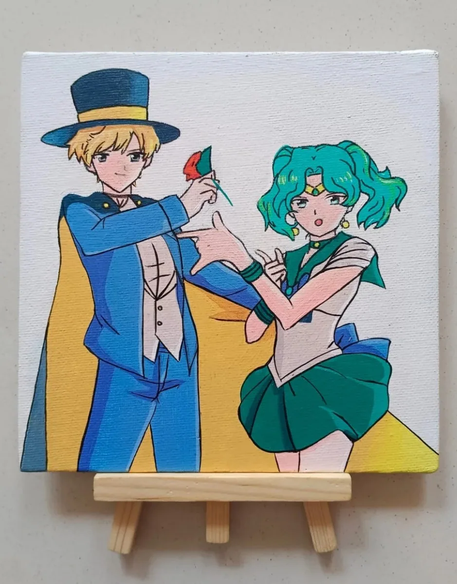 Hand-painted acrylic mini canvas featuring Sailor Uranus and Sailor Neptune from Sailor Moon, displayed on a small wooden easel.