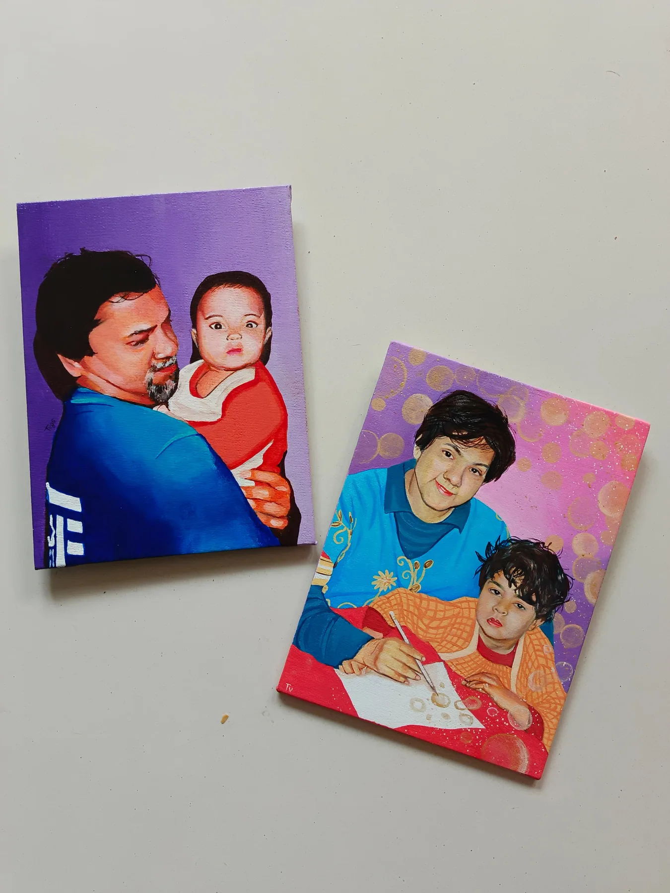 Two custom family portrait canvases showing a father with children, painted in bright colours as personal gifts.