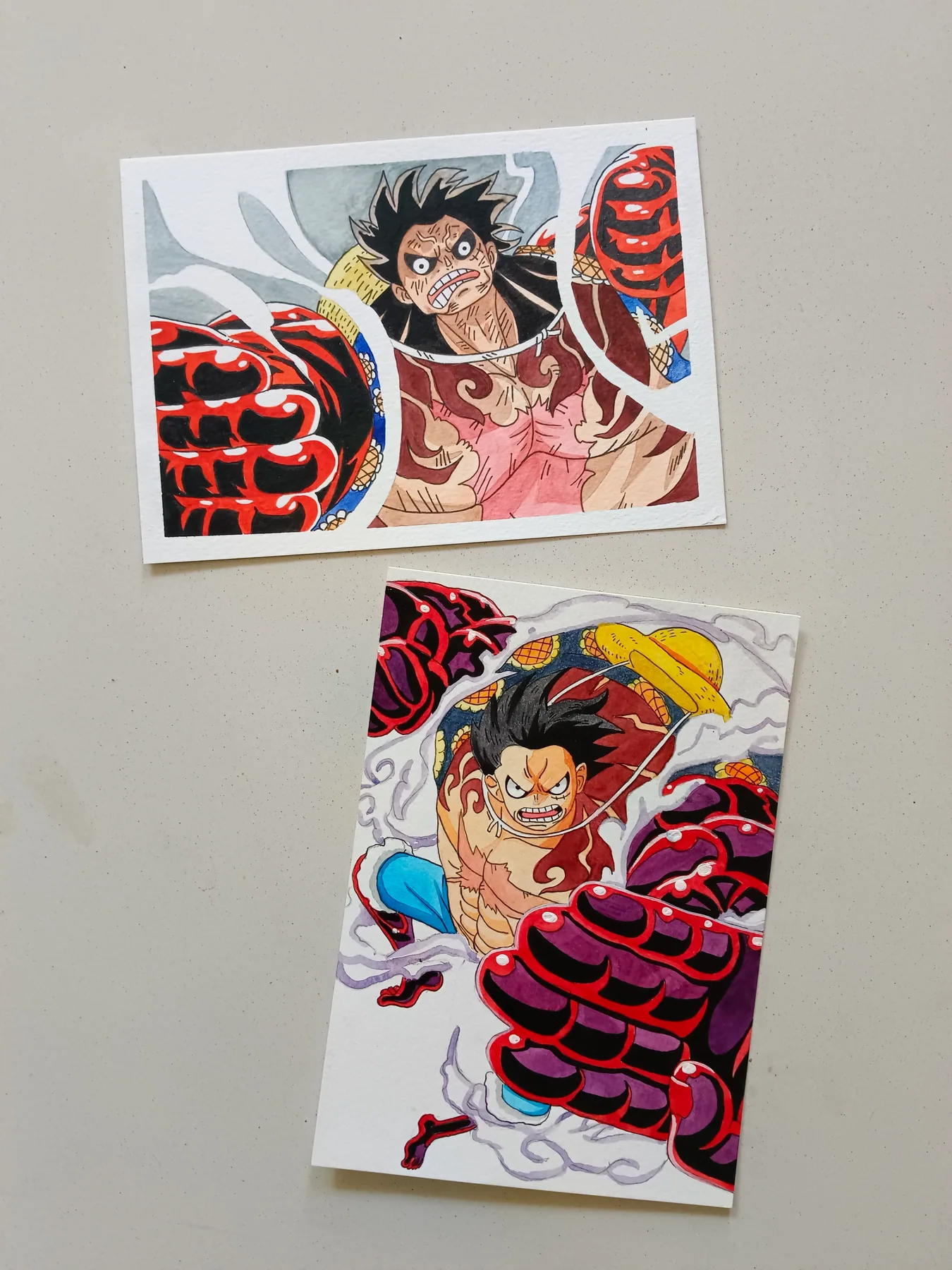 Pair of hand-painted acrylic One Piece artworks featuring Monkey D. Luffy in red-and-black action scenes.