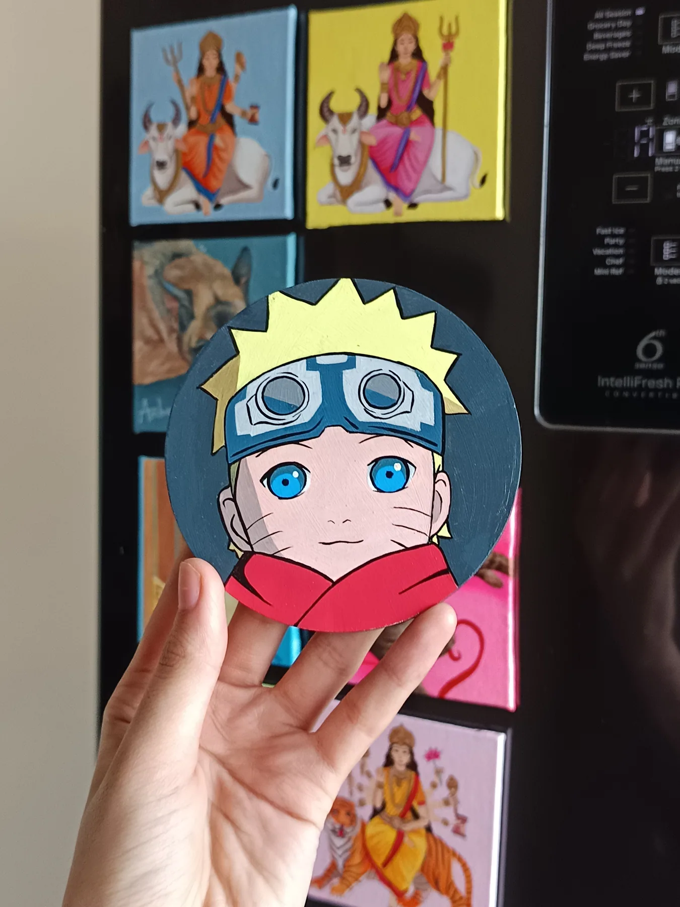 Hand-painted acrylic round mini canvas of Naruto Uzumaki from Naruto, held in hand as a custom fan-art commission sample.