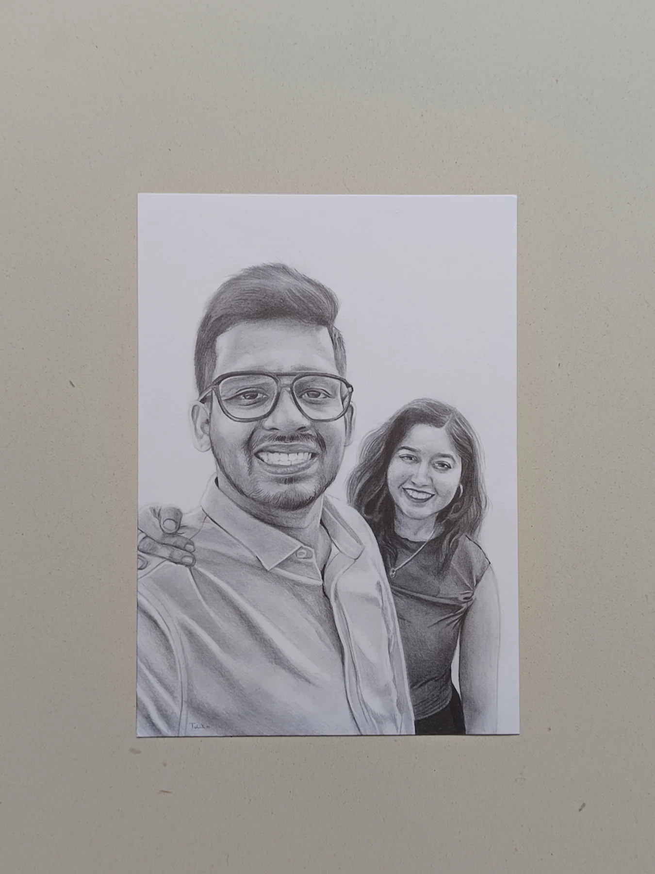 Graphite pencil portrait of a smiling couple from a photo, created as a personal custom art commission.