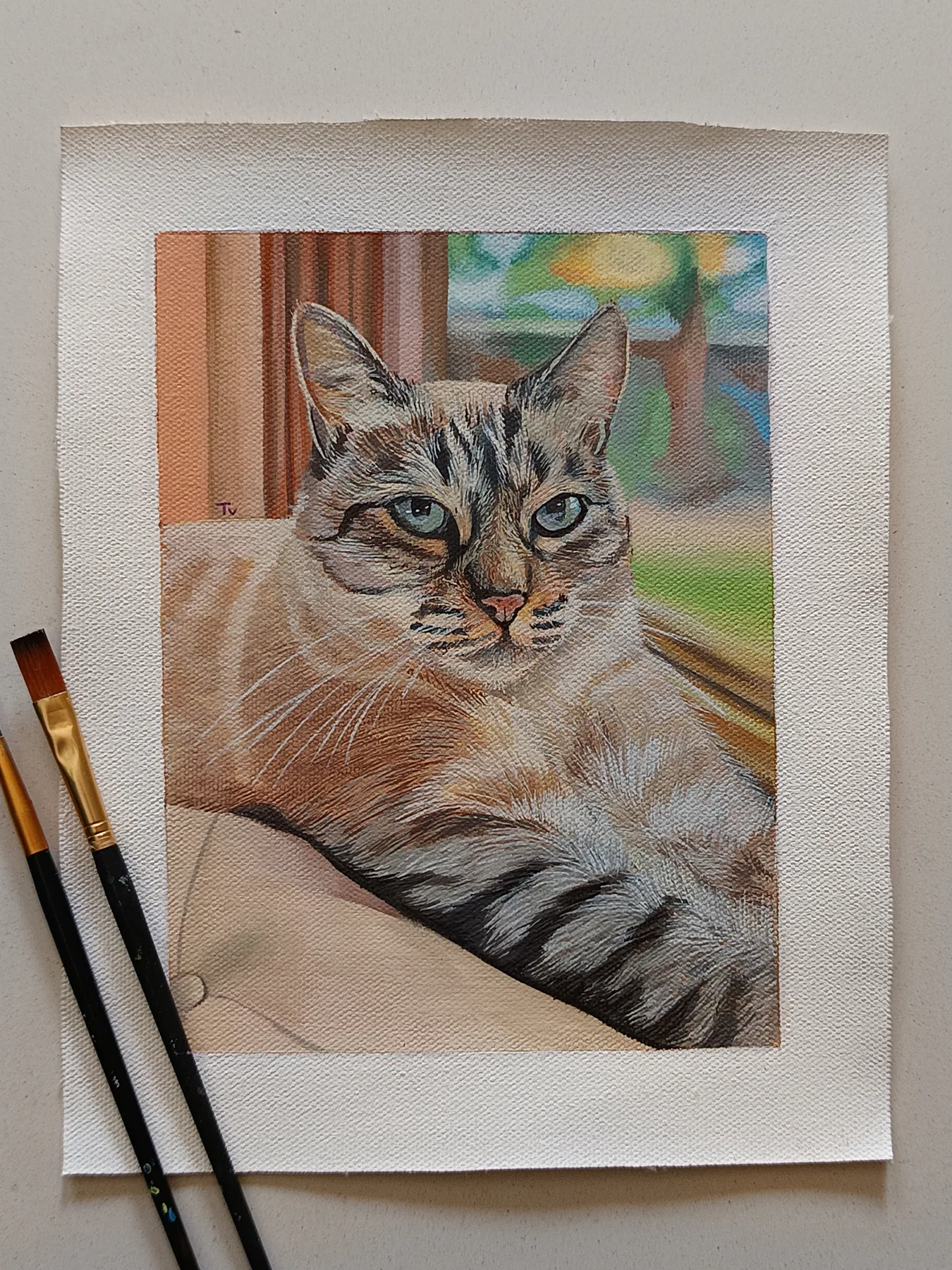 Detailed custom cat portrait painting from a photo, shown on paper with brushes beside the artwork.