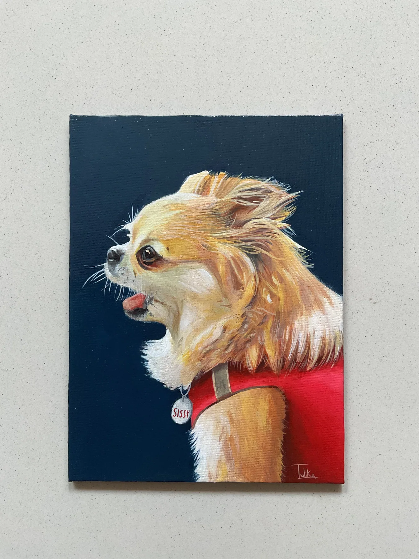 Custom pet portrait painting of a small light-coloured dog in a red harness against a dark blue background.