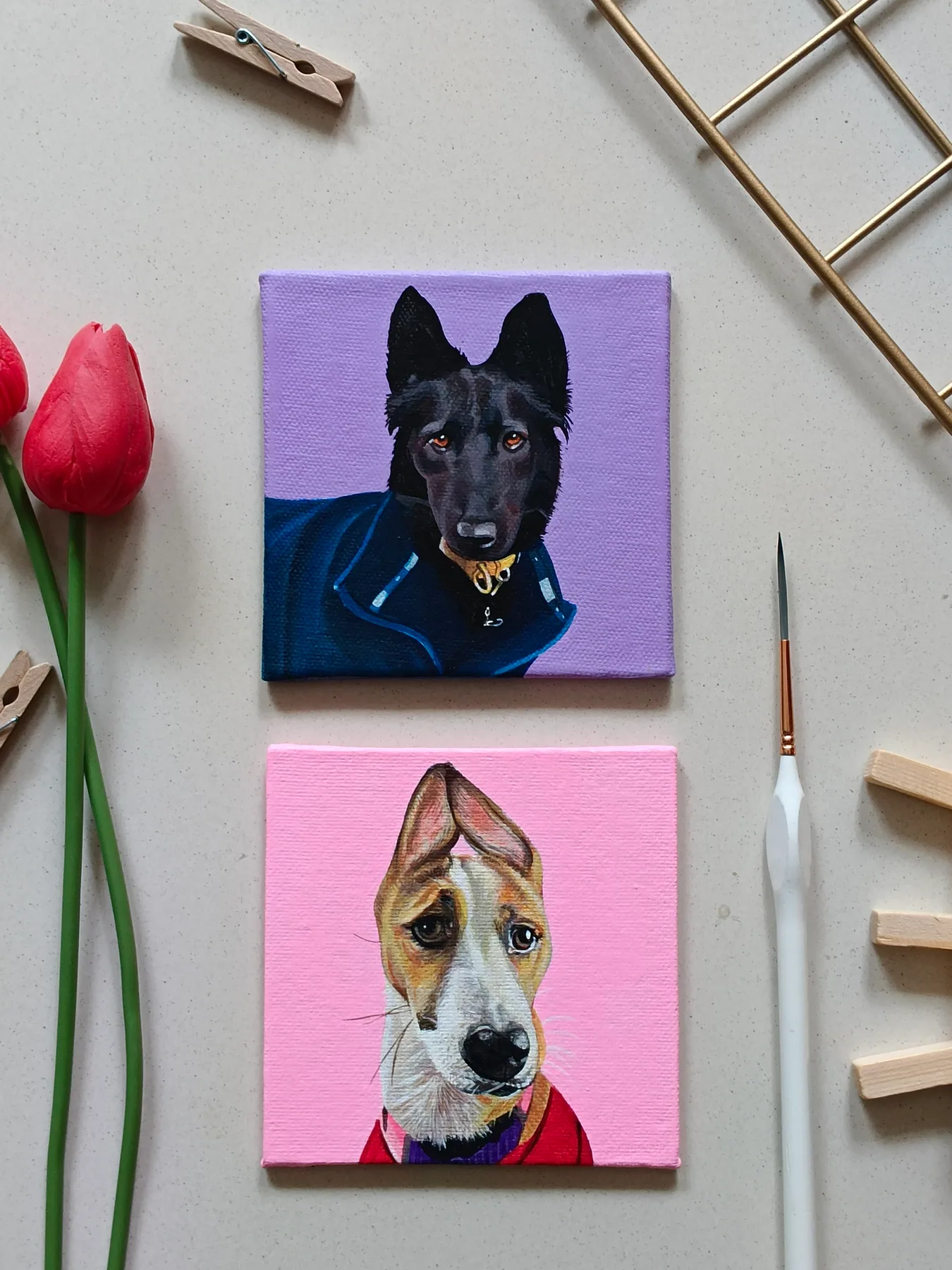 Two small dog portrait canvases with purple and pink backgrounds, shown with brushes and roses as pet art samples.
