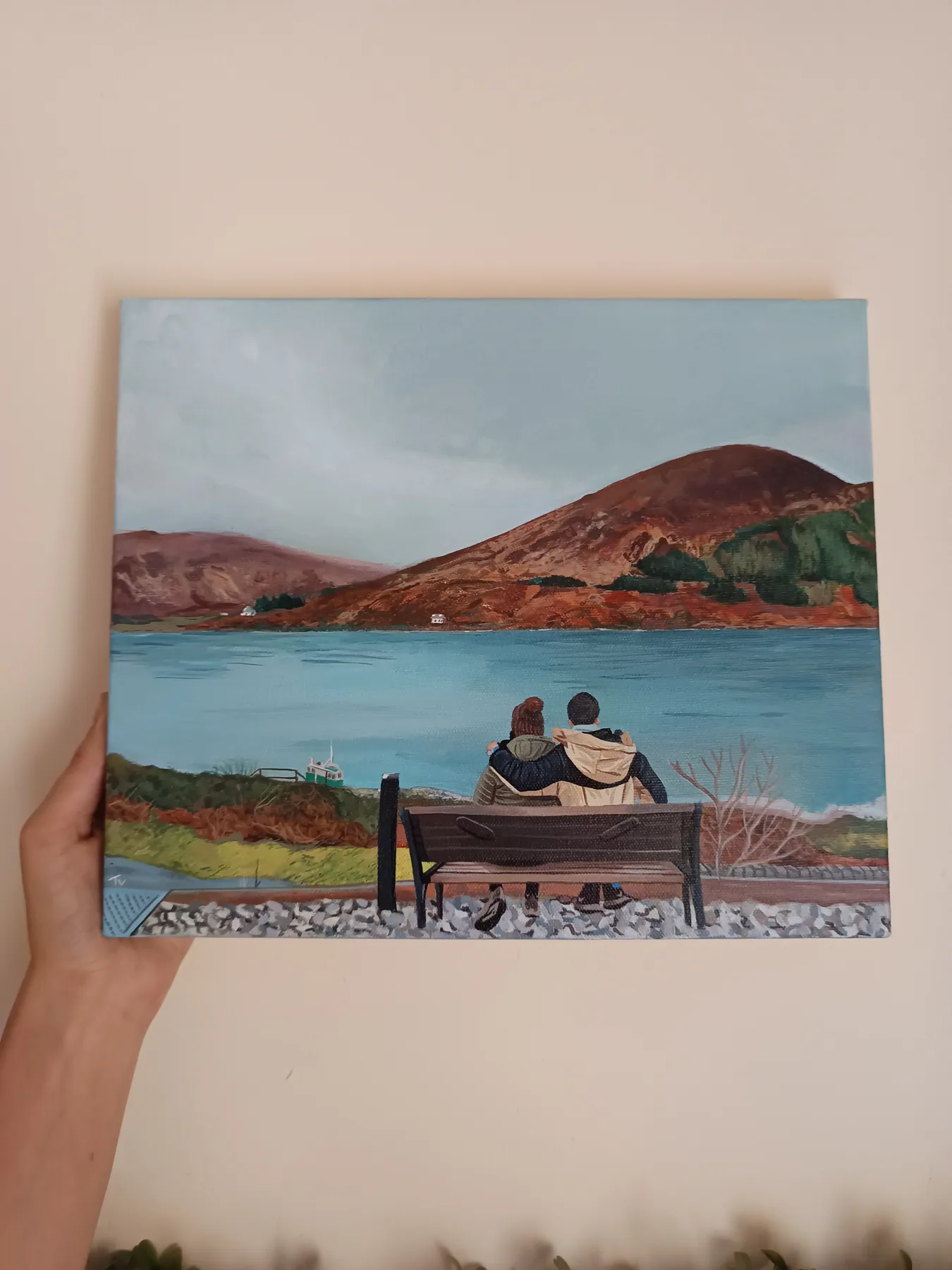 Custom romantic landscape painting of a couple sitting together by a lake, with soft hills and water in the background.