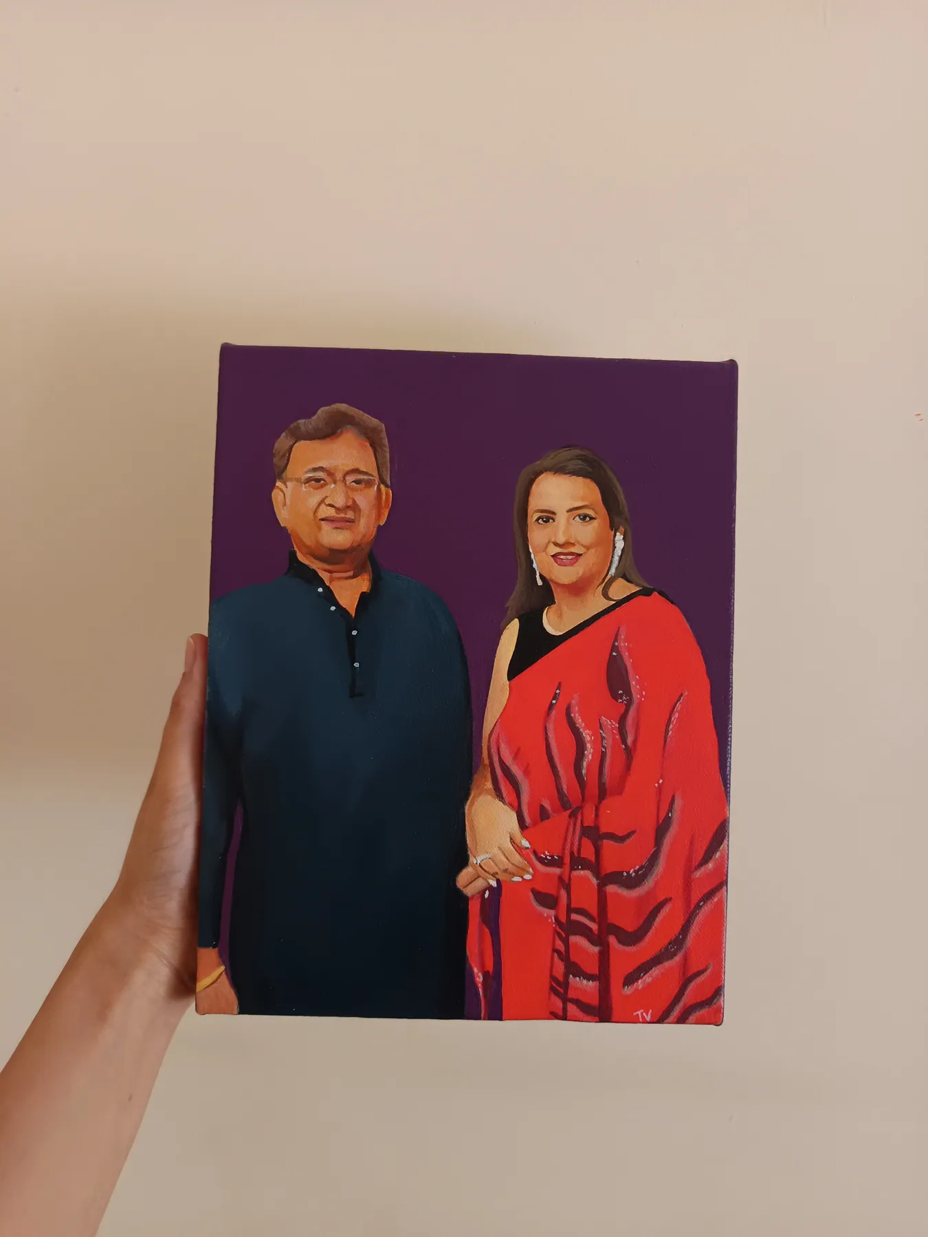 Custom couple portrait on a purple background, held in hand as a simple romantic commission example.