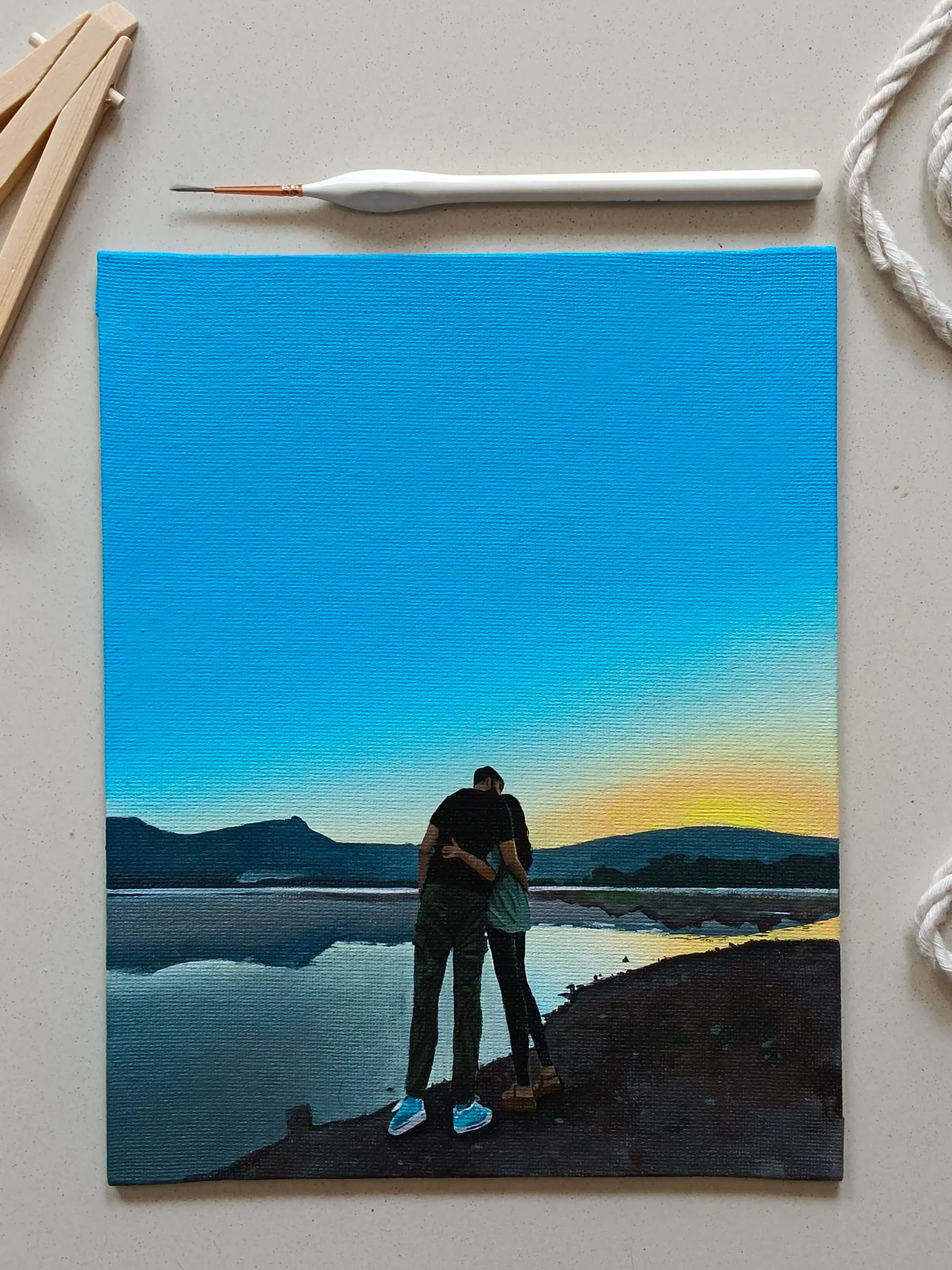 Romantic couple landscape painting of two people standing by water at sunset, made as a calm custom art gift.